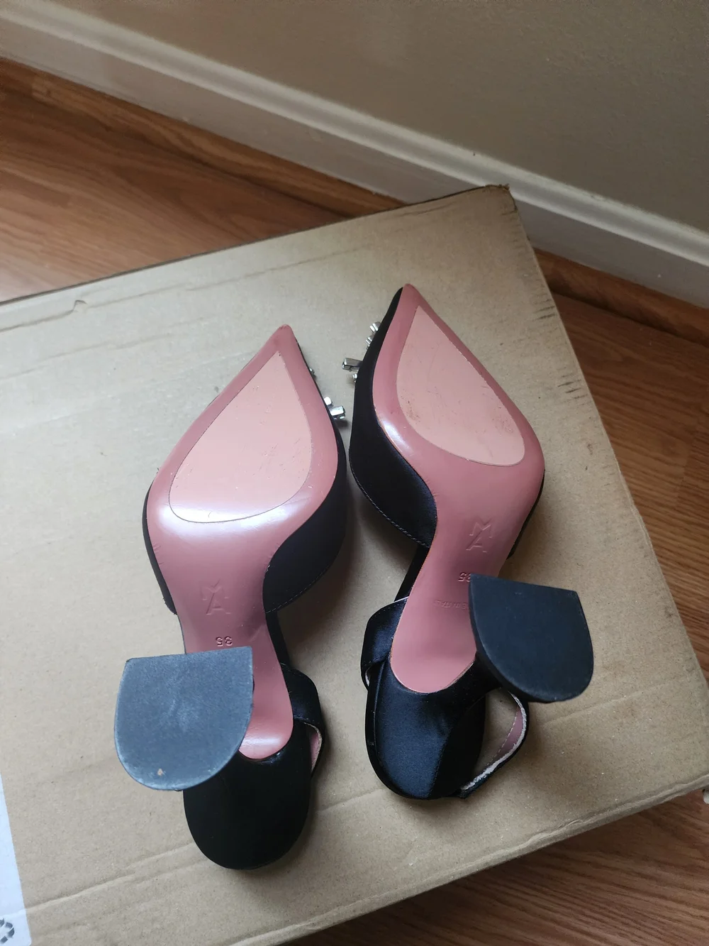 Amina Muaddi Black Satin Pointed Toe Heels with Crystal Sunburst Brooch